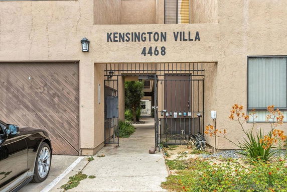 Front view of a building labeled Kensington Villa with gated entrance.