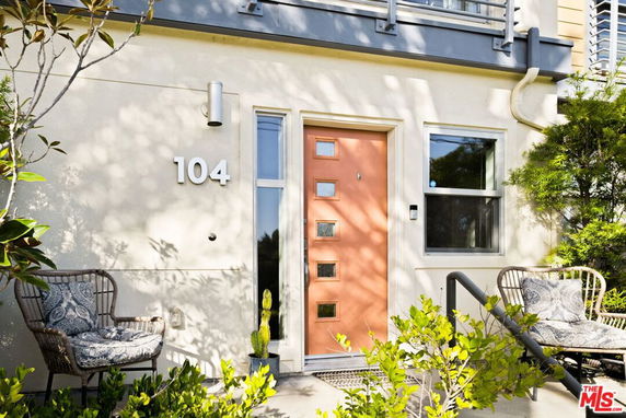 Front view of a house with a peach-colored door and house number 104.