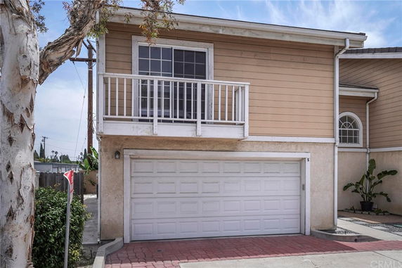 Front view of a house with an attached garage and a small balcony.