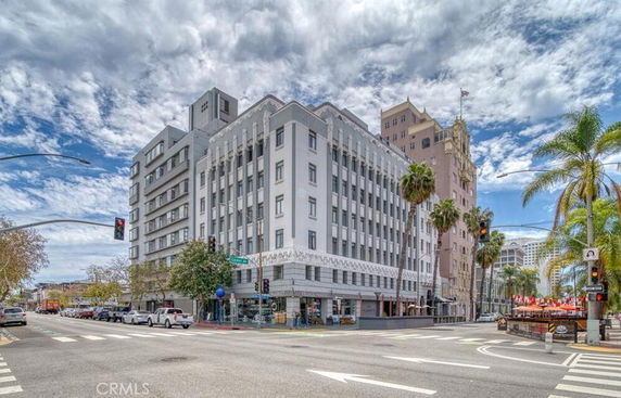 Front view of a multi-story building on a street corner.