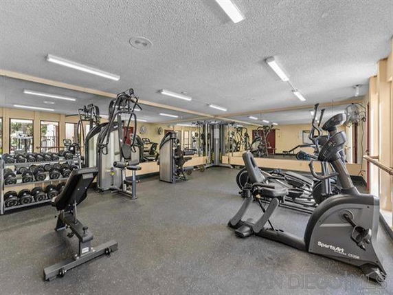 Indoor gym area with cardio and weightlifting equipment.