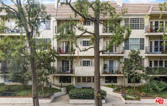 Front view of a multi-story residential building with balconies.
