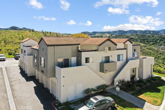 Front view of a two-story townhouse with multiple garages and staircases.