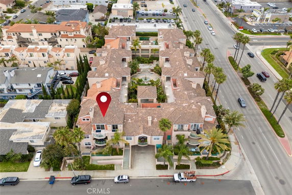 Aerial view of a residential complex with multiple buildings and adjacent roads.