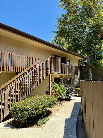Front view of a two-story building with external staircase.