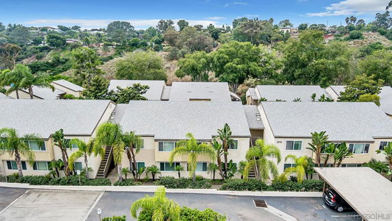 Apartment complex viewed from above with surrounding greenery.