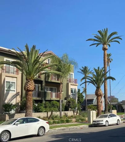 Front view of a multi-story building with balconies.