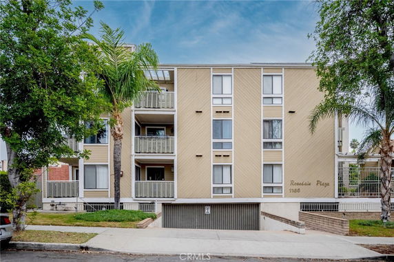 Front view of a multi-story residential building with balconies.