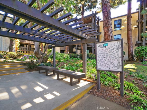 View of walkways and map display with building surrounding the area.