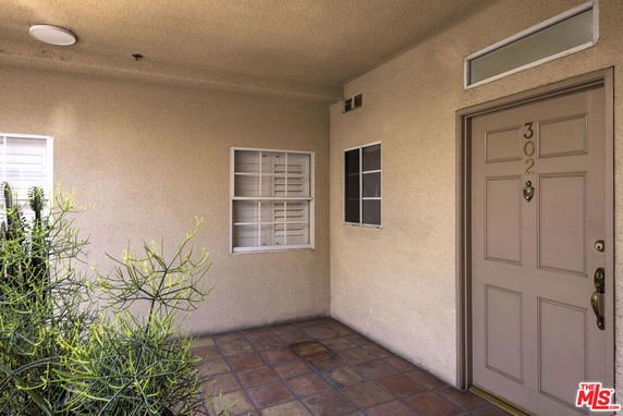 Front view of a building entrance with a door marked '302'.