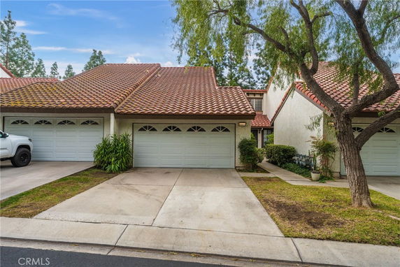 Front view of a house with a double garage and a tiled roof.