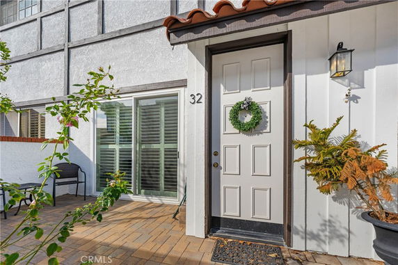 Front view of a house with a single door and a decorative wreath.