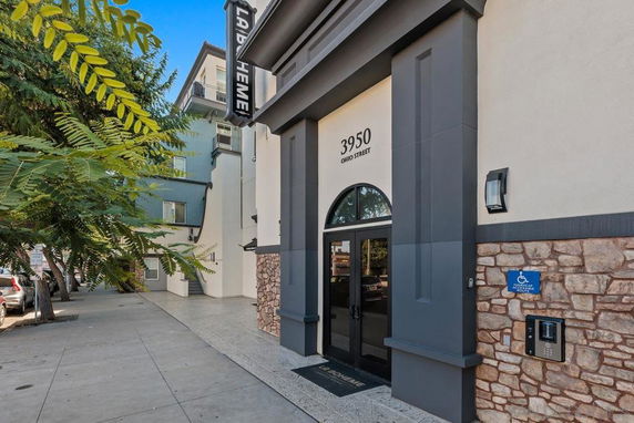 Front view of a multi-story building with a stone facade and entrance marked by address 3950 Ohio Street.