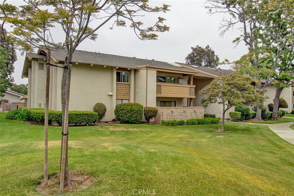 Front view of a two-story residential building with a balcony.