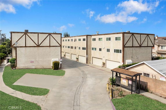 Front view of a multi-story building with garage doors.