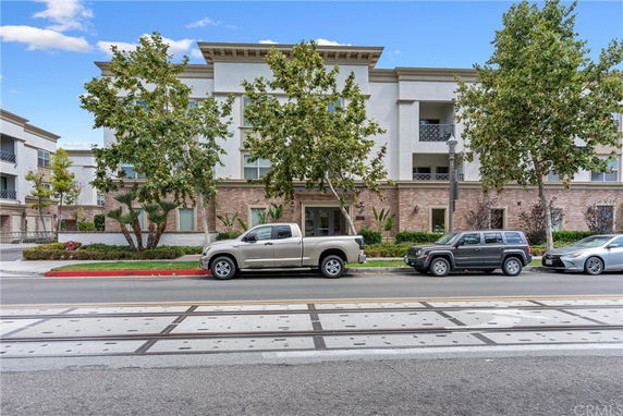 Front view of a multi-story residential building with a modern design and brick accents.