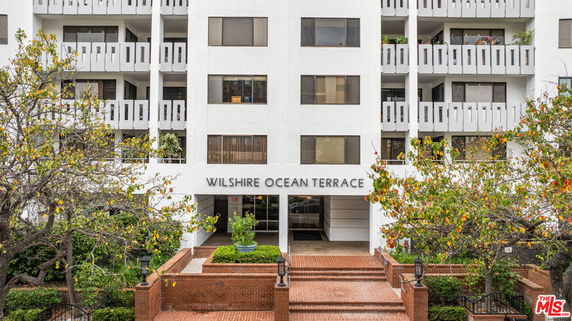Front view of a multi-story building with balconies named Wilshire Ocean Terrace.
