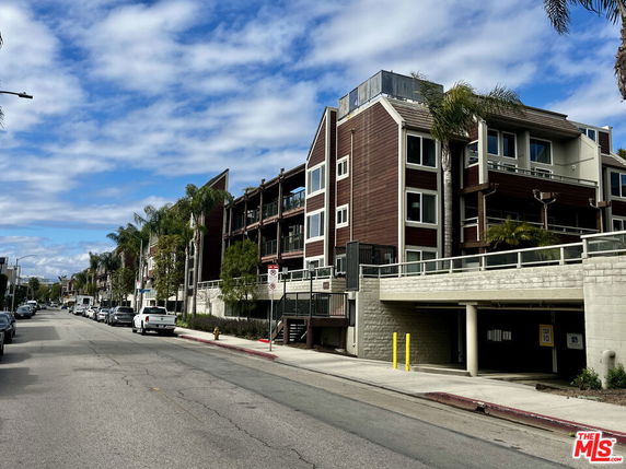 Front view of a multi-story residential building with balconies.