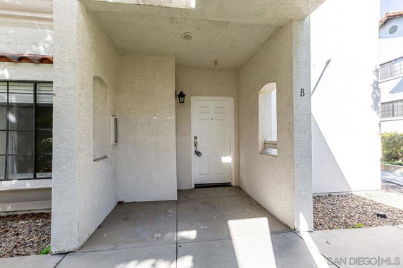 Front view of a building entrance with a single white door.