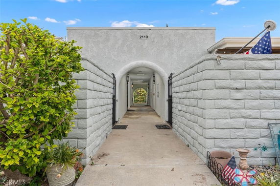 Front view of a building with an arched entrance and brick walls.