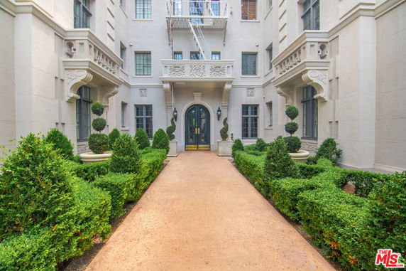 Front view of a multi-story building with decorative architectural elements and a central entrance.