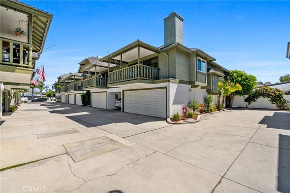 Front view of a building with balcony and garage.
