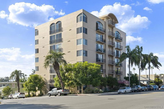 Front view of a multi-story residential building with balconies.