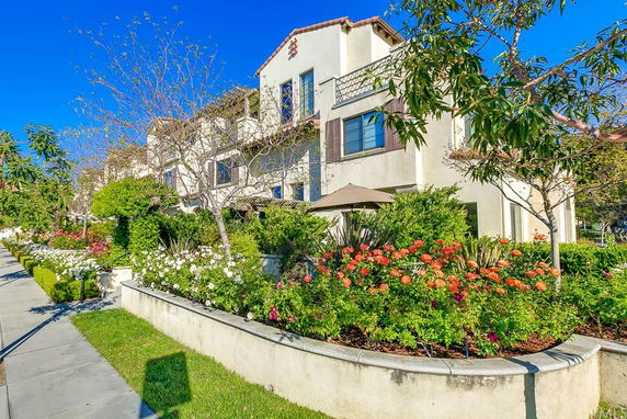Front view of a multi-story building with landscaped garden.