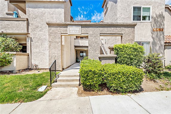 Front view of a residential building with a pathway leading to the entrance.