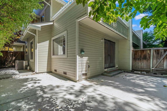Front view of a house with a paved patio area.