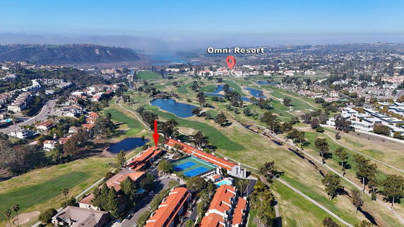 Panoramic view of a resort complex with golf course and surrounding areas.
