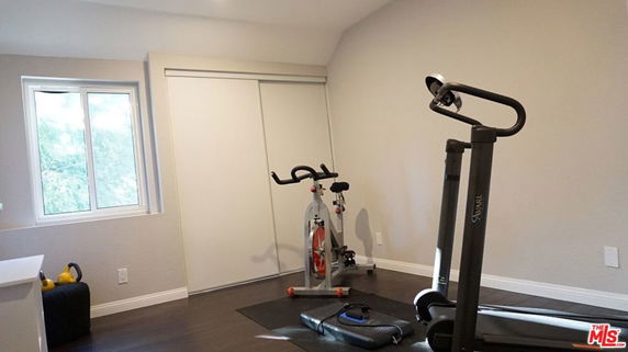 Interior view of a home gym with a treadmill and exercise bike.