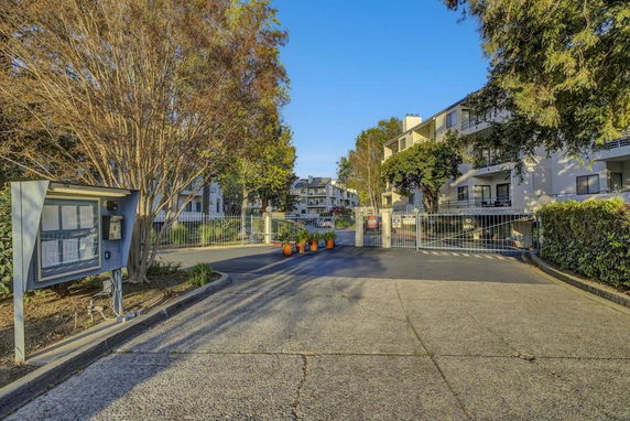 Front view of a residential building with gated entry.