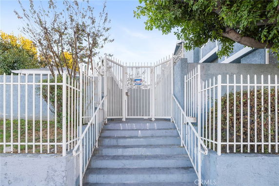 Front view of a gated entrance with stairs leading up