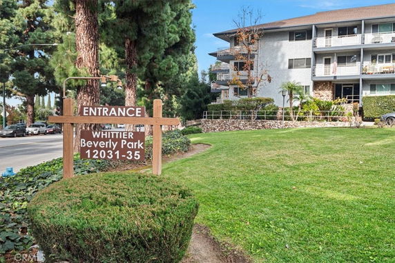 Front view of a multi-story building with balconies and a sign for Whittier Beverly Park.