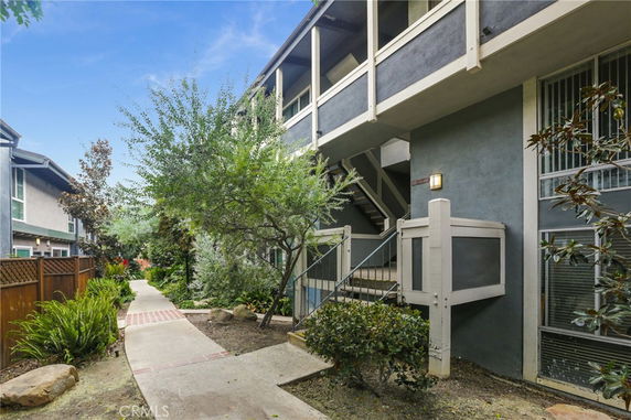 Front view of a two-story building with exterior staircases.
