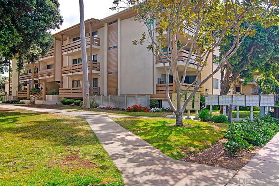 Front view of a multi-story residential building with balconies.