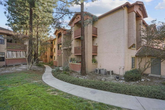 Front view of a multi-story residential building with balconies.
