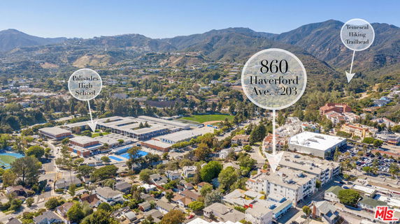 Panoramic view of a residential area with mountains in the background.