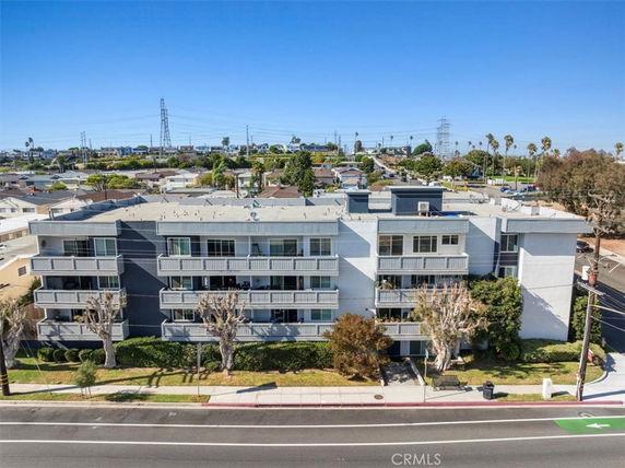 Front view of a multi-story apartment building with balconies.
