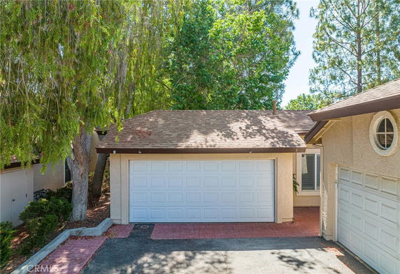 Front view of a single-story house with a garage door.