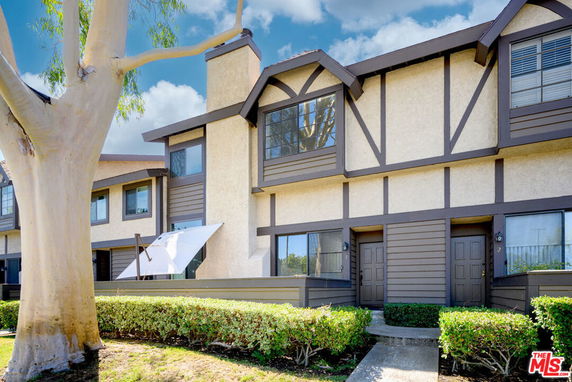 Front view of a multi-story building with Tudor-style architecture.