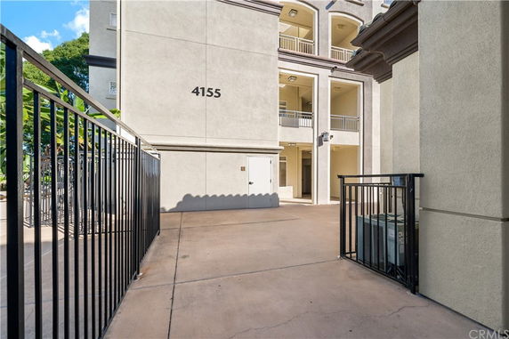 Front view of a multi-story building entrance with balconies.
