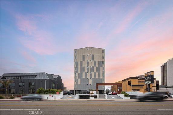 Front view of a multi-story building with modern architectural design.