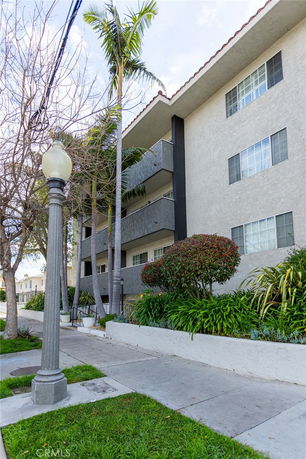 Front view of a multi-story residential building with balconies.