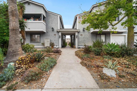Front view of a two-story residential building with balconies.
