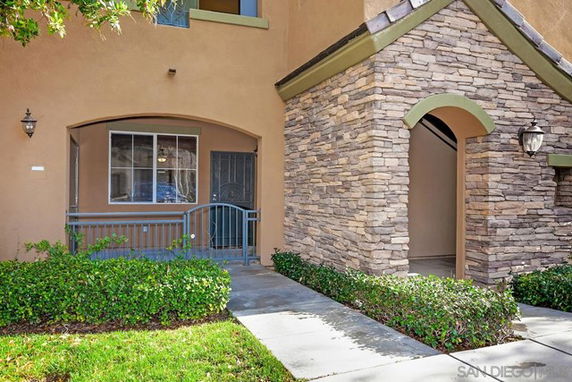 Front view of a building with stone accents and an arched entryway.