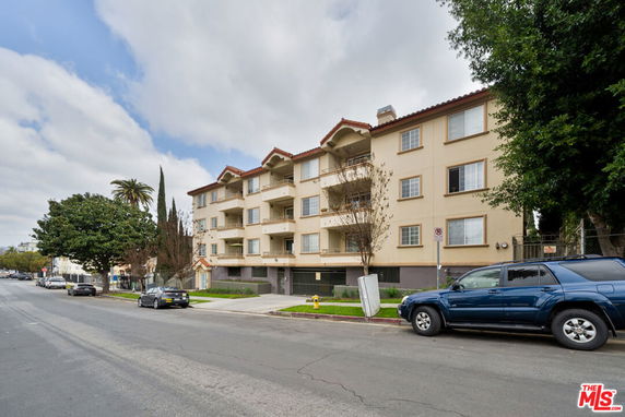 Front view of a multi-story residential building with balconies.
