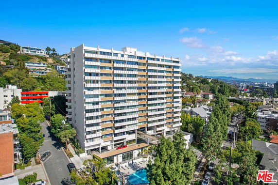 Front view of a multi-story residential building with balconies.