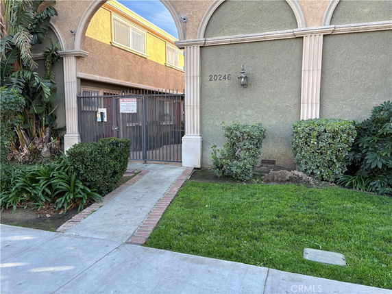 Front view of a building entrance with an archway and gate.